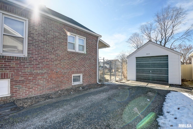 view of property exterior featuring a garage and an outdoor structure