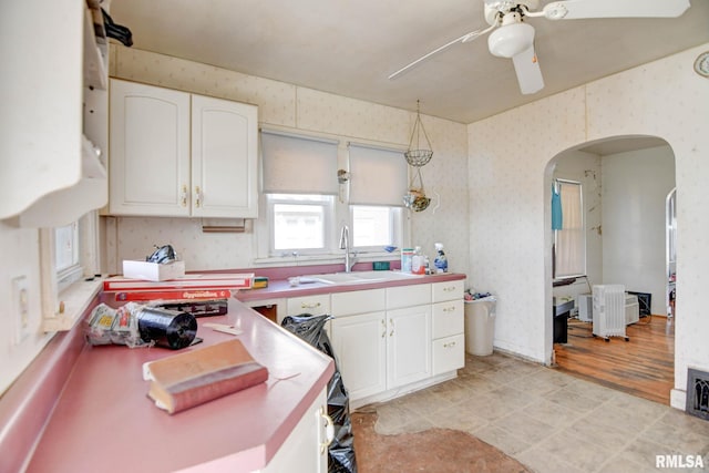 kitchen featuring sink, decorative light fixtures, white cabinets, and ceiling fan