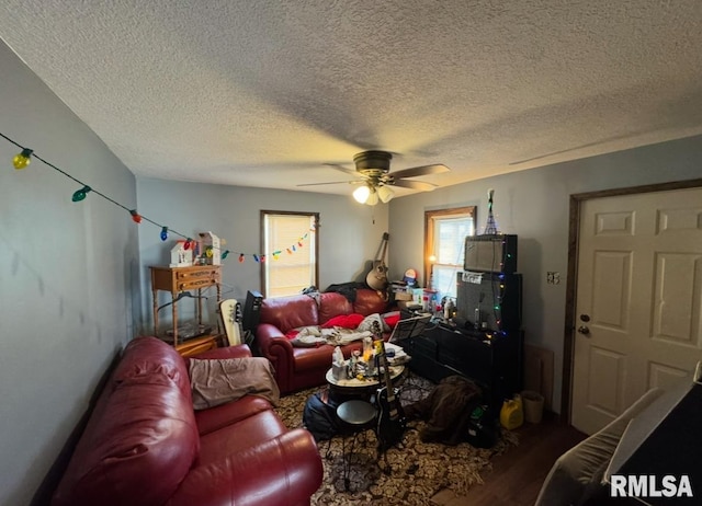 living room with hardwood / wood-style floors, a textured ceiling, and ceiling fan