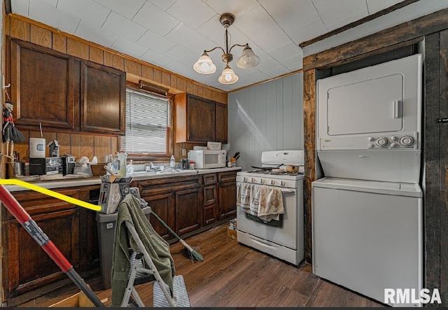 1405 Pekin St, Lincoln, IL 62656 - kitchen featuring white appliances, stacked washer / drying machine, dark wood-type flooring, wood walls, and light countertops