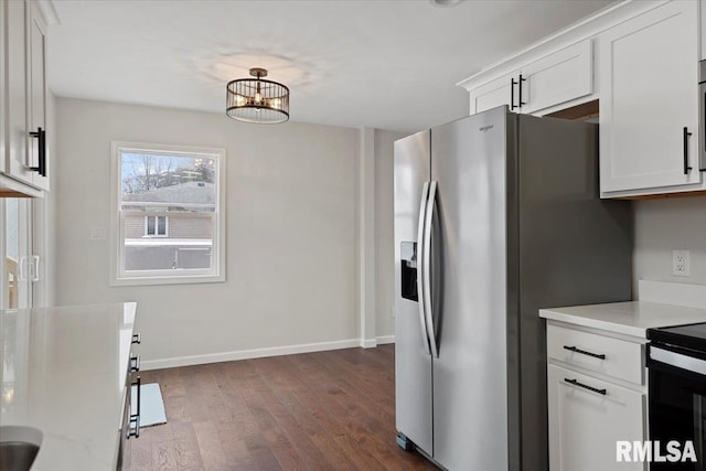 kitchen with dark wood-type flooring, white cabinetry, stainless steel refrigerator with ice dispenser, light stone counters, and range with electric stovetop