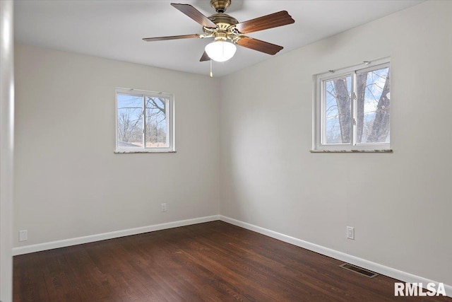 spare room with ceiling fan and dark hardwood / wood-style floors