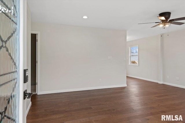 empty room featuring dark hardwood / wood-style flooring and ceiling fan