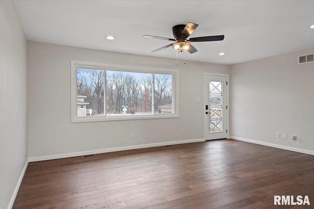 unfurnished room with ceiling fan and dark hardwood / wood-style flooring