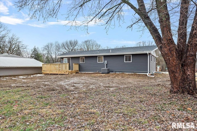 rear view of house with a deck and central air condition unit