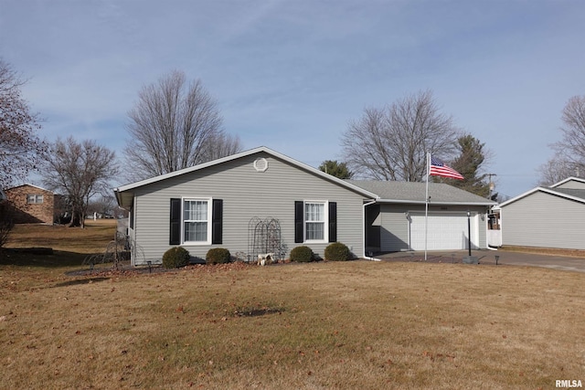 back of property with a garage and a yard