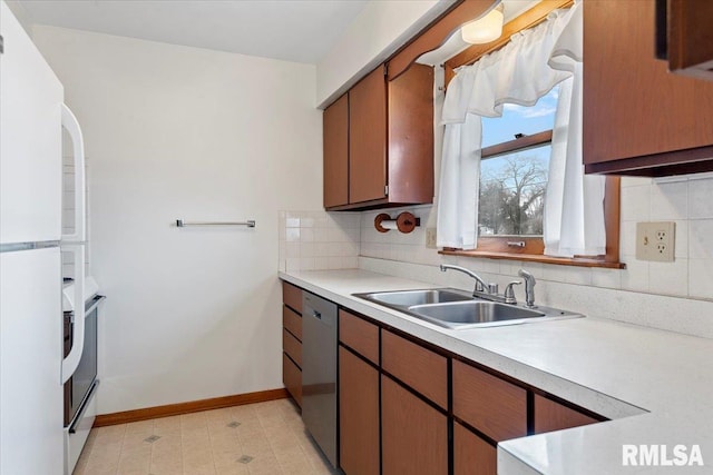 kitchen featuring sink, backsplash, dishwasher, and white fridge