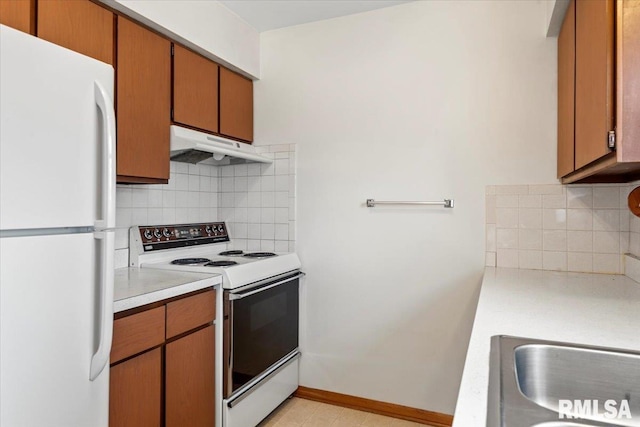 kitchen featuring backsplash, white appliances, and sink