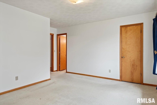 carpeted empty room featuring a textured ceiling