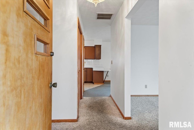 hall with light colored carpet