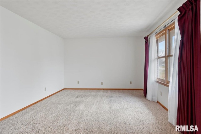 carpeted empty room with a textured ceiling