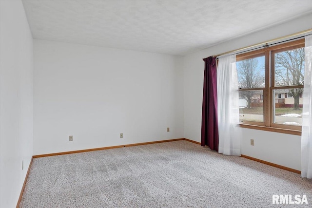 carpeted spare room with a textured ceiling