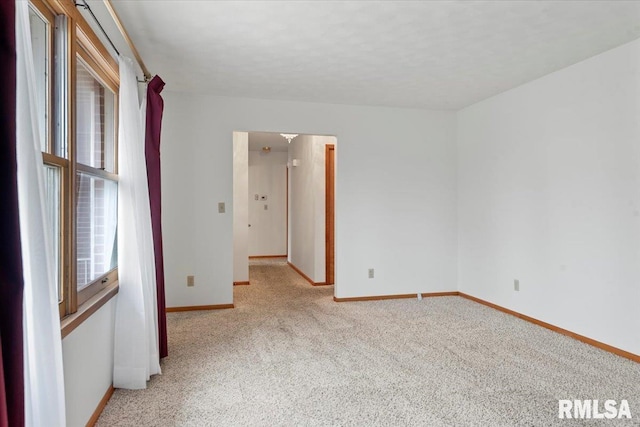 spare room with light colored carpet