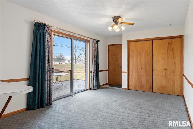 unfurnished bedroom featuring light colored carpet, access to exterior, ceiling fan, and a closet