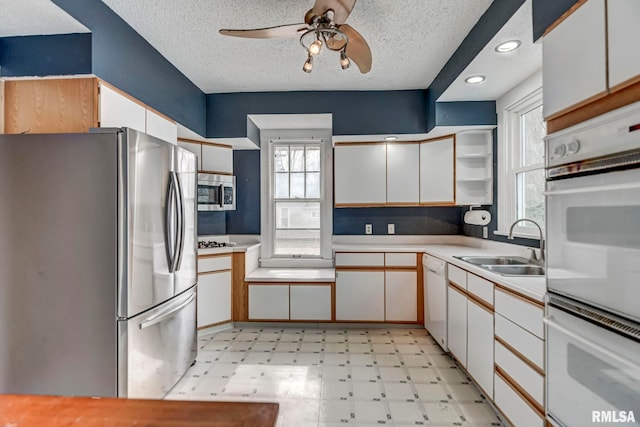 kitchen with white cabinetry, appliances with stainless steel finishes, and sink