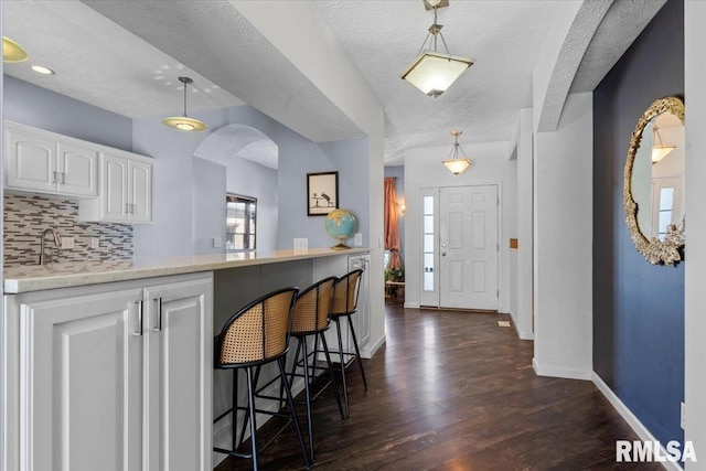 foyer with dark hardwood / wood-style floors and a textured ceiling