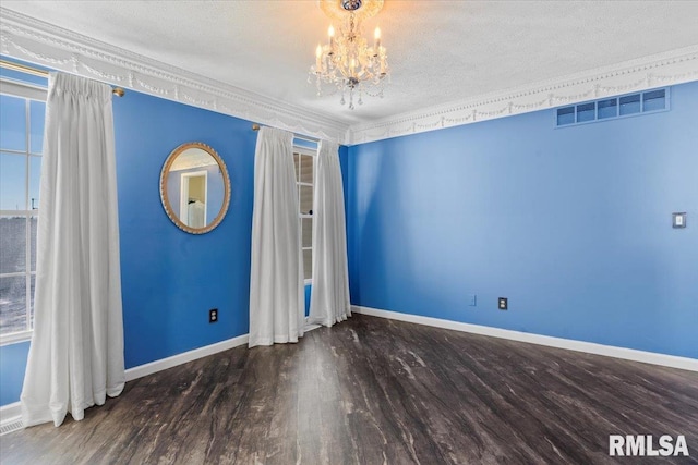 interior space featuring dark wood-type flooring, crown molding, a textured ceiling, and a notable chandelier