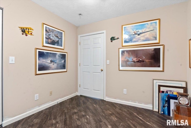 foyer entrance featuring dark hardwood / wood-style flooring and a textured ceiling