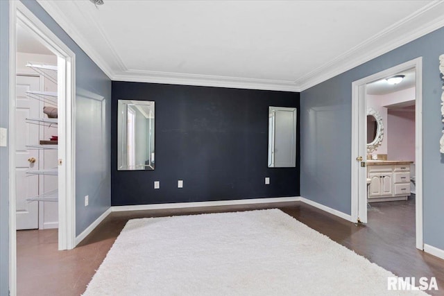 unfurnished bedroom with crown molding, ensuite bath, and dark wood-type flooring