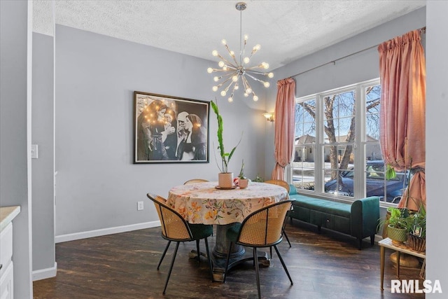 dining area with dark hardwood / wood-style floors, an inviting chandelier, and a textured ceiling