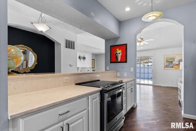 kitchen featuring white cabinetry, ceiling fan, a textured ceiling, and stainless steel range with electric stovetop