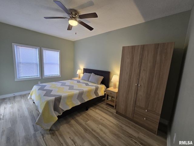 bedroom featuring ceiling fan and light hardwood / wood-style floors