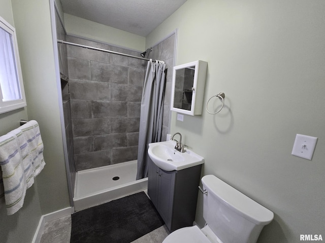 bathroom featuring vanity, curtained shower, and toilet