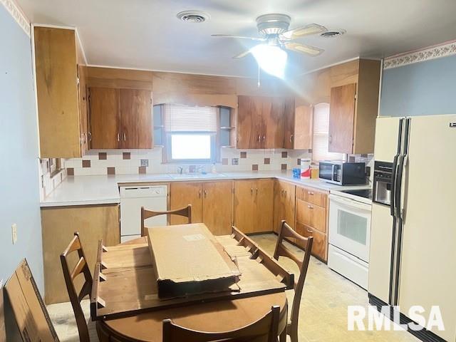 kitchen featuring ceiling fan, white appliances, sink, and decorative backsplash