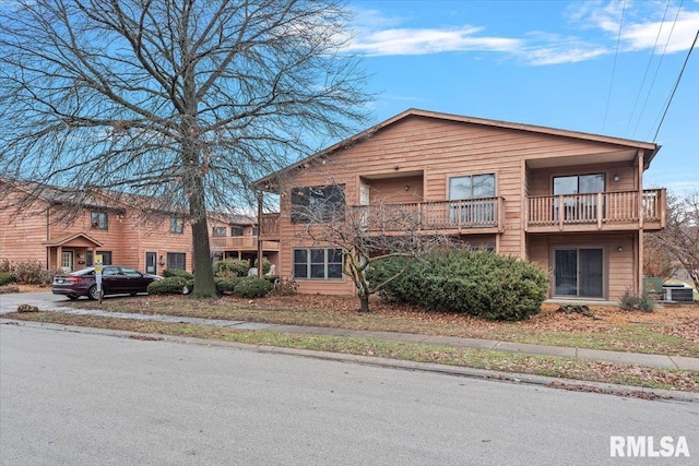 view of front of house with a balcony and central AC unit