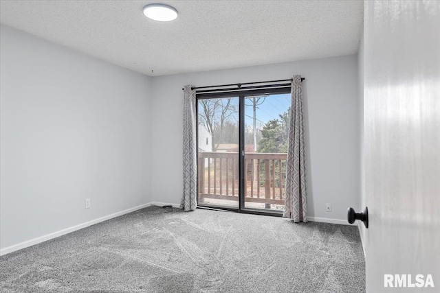 empty room with a textured ceiling and carpet