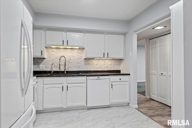 kitchen with sink, backsplash, white cabinets, white appliances, and a textured ceiling