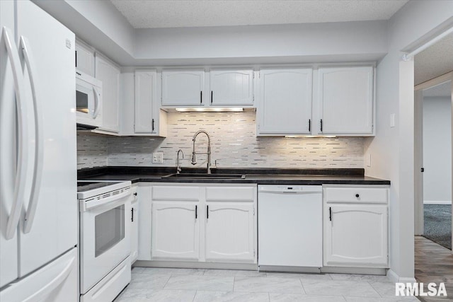 kitchen featuring tasteful backsplash, sink, white appliances, and white cabinets