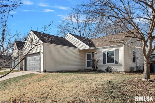 ranch-style home with a garage and a front lawn