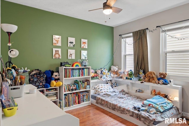 bedroom with wood-type flooring and ceiling fan