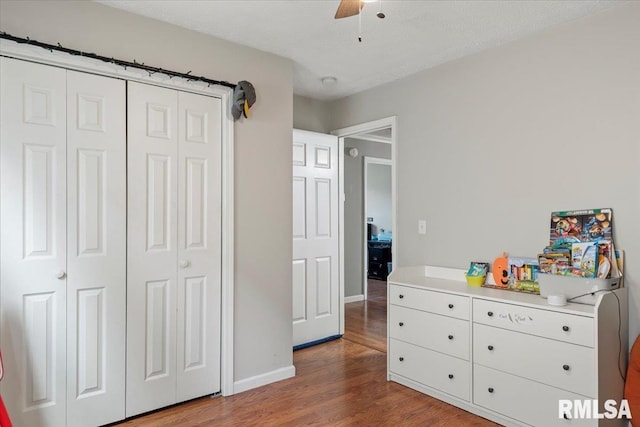 bedroom featuring wood-type flooring, a closet, and ceiling fan