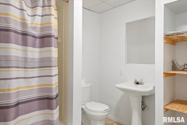 bathroom featuring sink, a paneled ceiling, and toilet