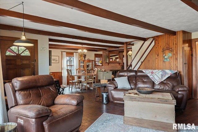 living room with beamed ceiling, dark wood-type flooring, a fireplace, and wooden walls