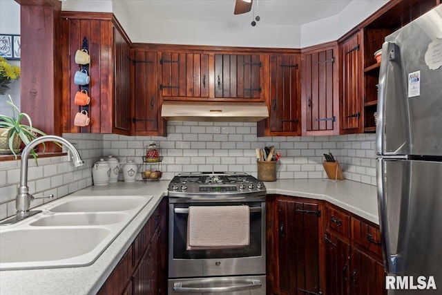 kitchen featuring ceiling fan, appliances with stainless steel finishes, sink, and decorative backsplash