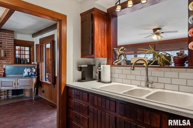 kitchen with tasteful backsplash, sink, dark hardwood / wood-style flooring, and ceiling fan