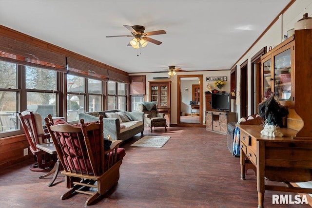 living room featuring crown molding, dark hardwood / wood-style floors, a wall mounted air conditioner, and ceiling fan