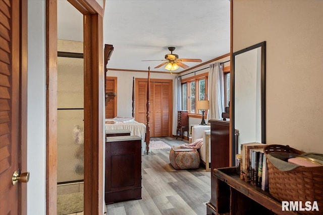 bedroom featuring ornamental molding and light hardwood / wood-style flooring