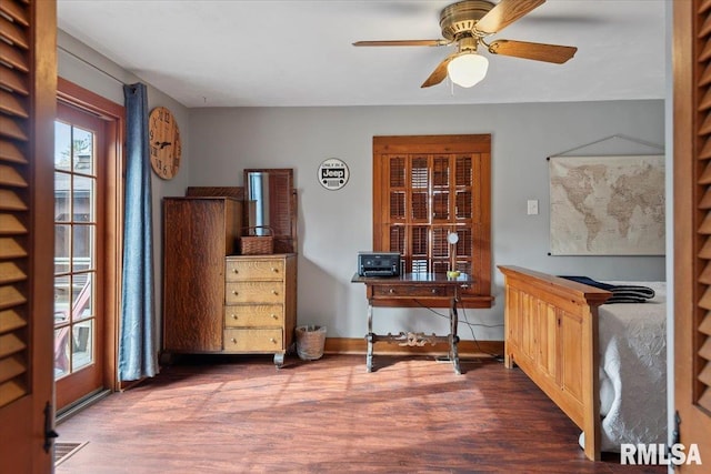 home office with dark hardwood / wood-style flooring and ceiling fan