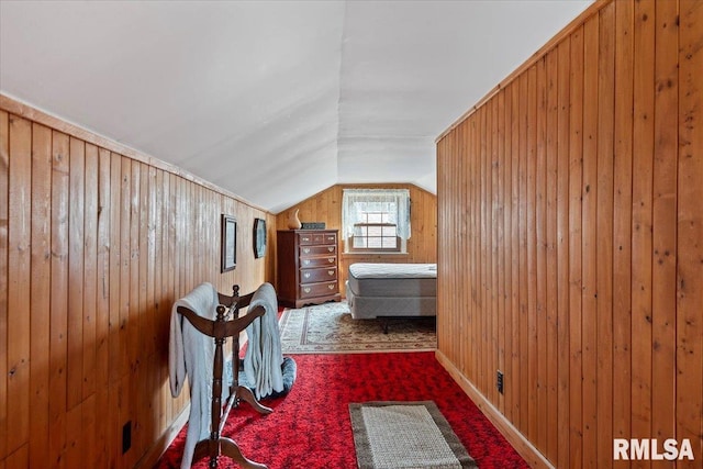 corridor with lofted ceiling, carpet, and wooden walls