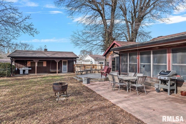 exterior space featuring a patio area, a sunroom, and a deck