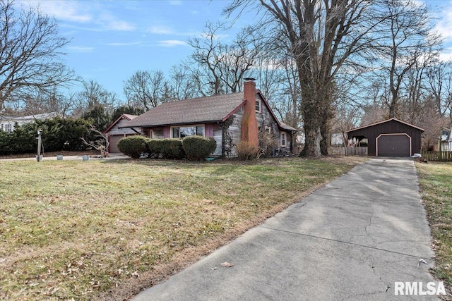 view of home's exterior with a garage, a yard, and an outdoor structure