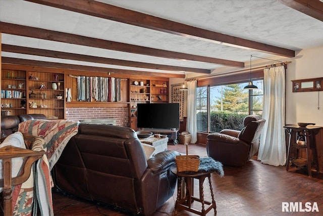 living room featuring dark hardwood / wood-style flooring, a textured ceiling, built in features, and beam ceiling