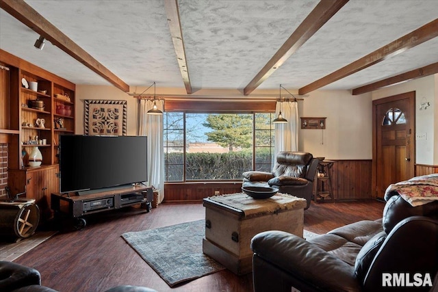 living room featuring beamed ceiling, dark hardwood / wood-style flooring, and wood walls