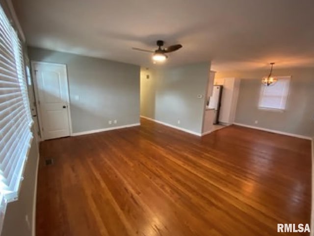 spare room with dark wood-type flooring and ceiling fan