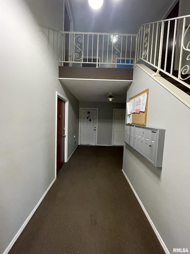 hallway with a high ceiling and a mail area