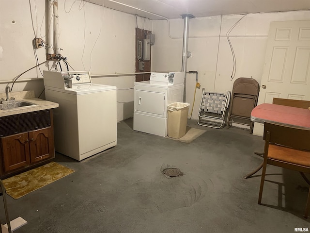 basement featuring separate washer and dryer and sink